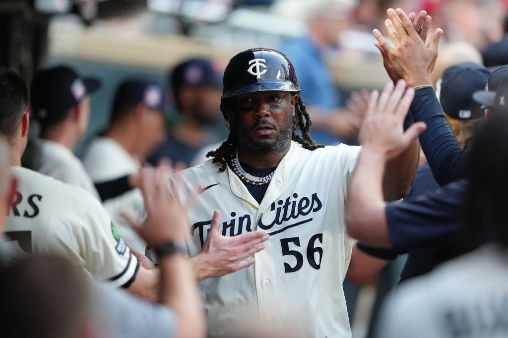 Minnesota Twins' Josh Bell celebrates in the dugout after scoring during the sixth inning of a baseball game against the Athletics, Saturday, July 25, 2026, in Minneapolis. (AP Photo/Ellen Schmidt)