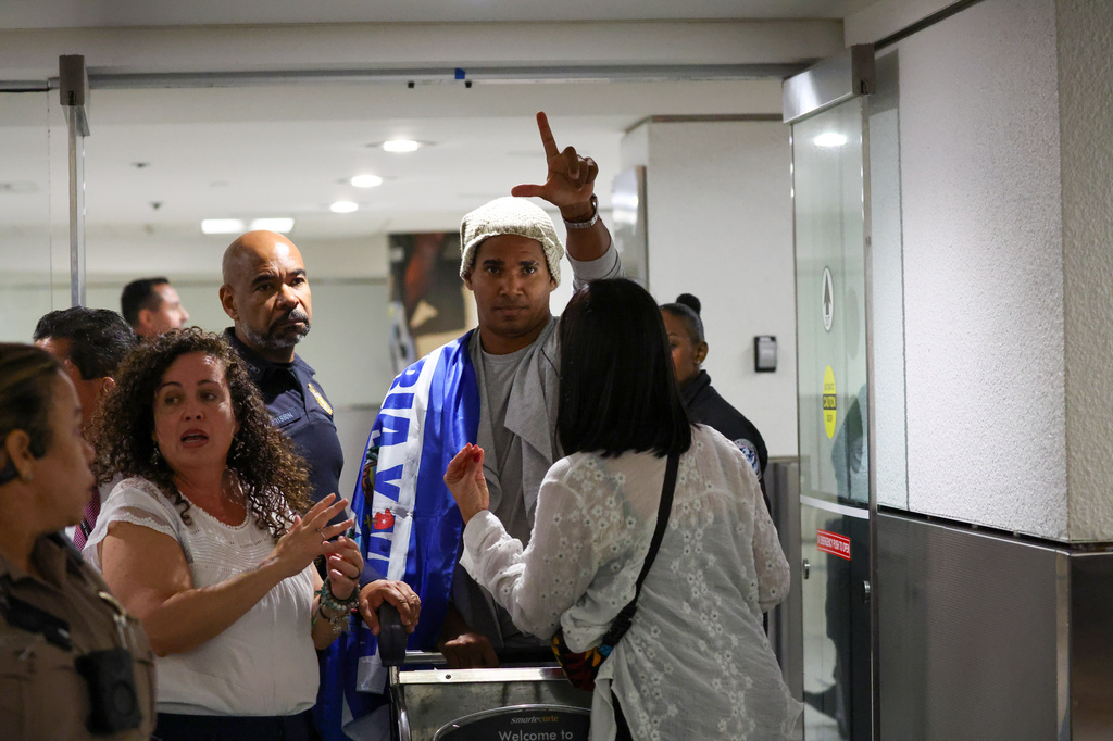 Cuban dissident artist Luis Manuel Otero Alcántara reacts after arriving at Miami International Airport on Saturday, July 18, 2026, after serving a five-year prison sentence in Cuba. (AP Photo/David Santiago)