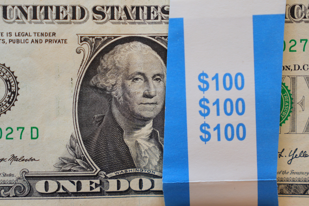 A portrait of George Washington is displayed on a stack of U.S. one-dollar bills in Dallas, Tuesday, April 7, 2026. (AP Photo/LM Otero)