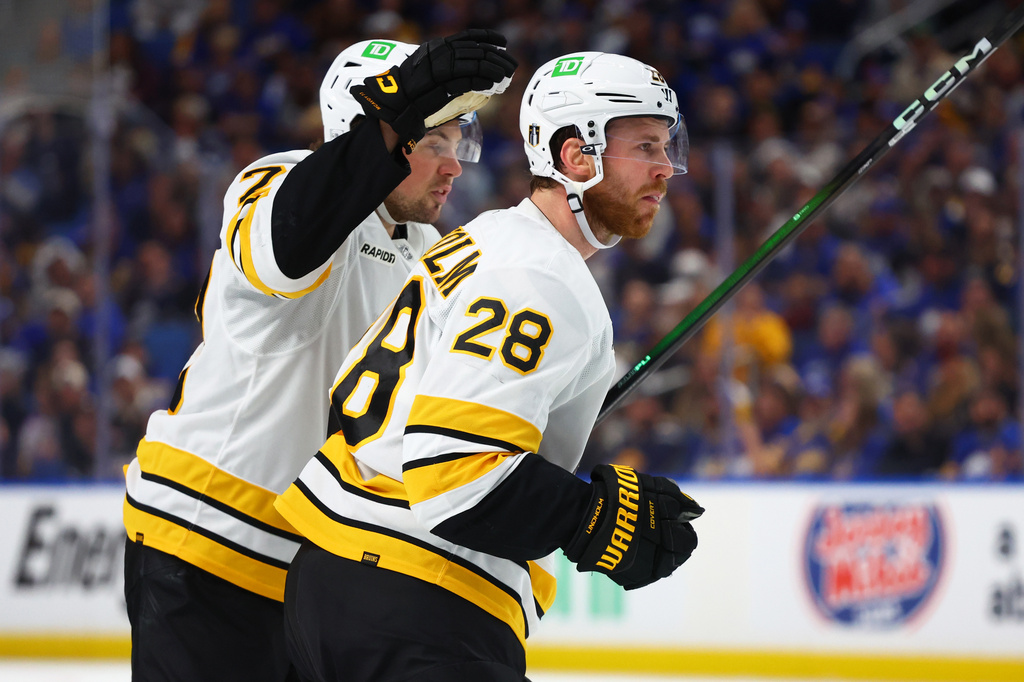 Boston Bruins center Elias Lindholm (28) celebrates his goal with defenseman Charlie McAvoy (73)during the second period in Game 5 of a first-round NHL hockey Stanley Cup playoff series against the Buffalo Sabres Tuesday, April 28, 2026, in Buffalo, N.Y. (AP Photo/Jeffrey T. Barnes)