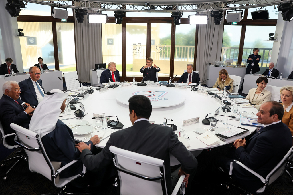 Japan's Prime Minister Sanae Takaichi, Germany's Chancellor Friedrich Merz, Italy's Prime Minister Giorgia Meloni, President Donald Trump, European Commission President Ursula von der Leyen, Canadian Prime Minister Mark Carney, Britain's Prime Minister Keir Starmer, European Council President Antonio Costa, French President Emmanuel Macron, Emir of Qatar, Sheikh Tamim bin Hamad Al Thani, President of the United Arab Emirates (UAE) Sheikh Mohamed bin Zayed Al Nahyan and Egyptian President Abdel Fattah al-Sisi, at a working lunch with leaders of G7 and the Middle East in Evian-les-Bains, France, Tuesday, June 16, 2026. (Christian Hartmann/Pool Photo via AP)