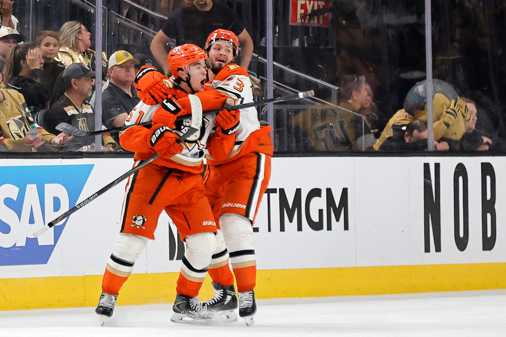 Anaheim Ducks defenseman Olen Zellweger (51) celebrates with center Mason McTavish (23) after scoring against the Vegas Golden Knights during the third period in Game 5 of a second-round NHL hockey Stanley Cup playoff series Tuesday, May 12, 2026, in Las Vegas. (Steve Marcus/Las Vegas Sun via AP)
