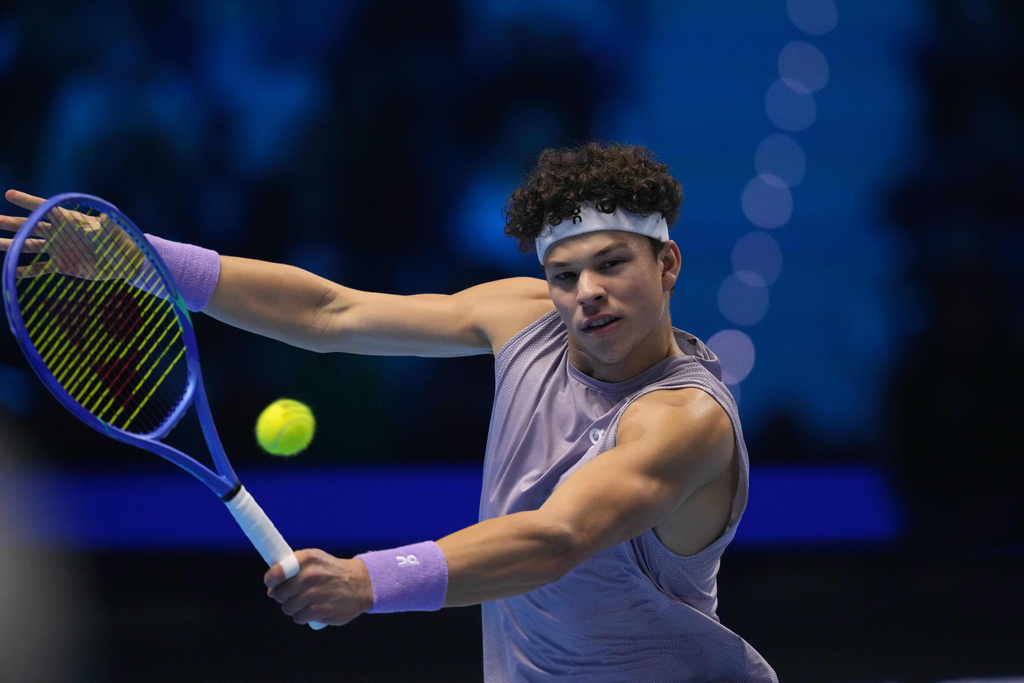 United States' Ben Shelton returns the ball to Germany's Alexander Zverev during their singles tennis match of the ATP World Tour Finals, in Turin, Italy, Sunday, Nov. 9, 2025. (AP Photo/Antonio Calanni)