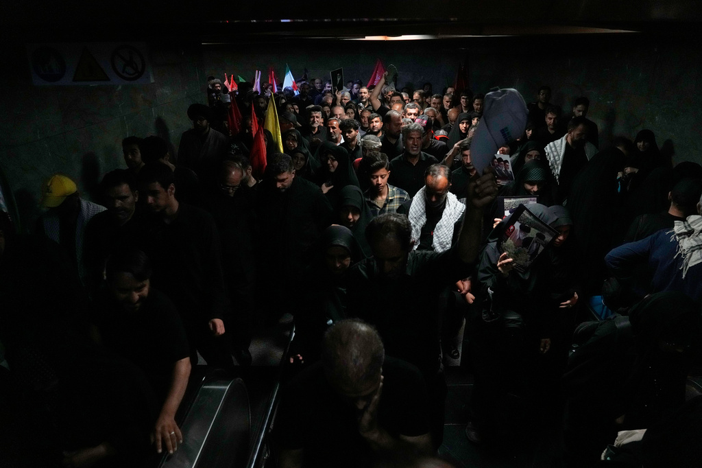 Mourners walk through a subway station as they make their way to the funeral procession of the slain Iranian Supreme Leader Ayatollah Ali Khamenei in Tehran, Iran, Monday, July 6, 2026. (AP Photo/Vahid Salemi)