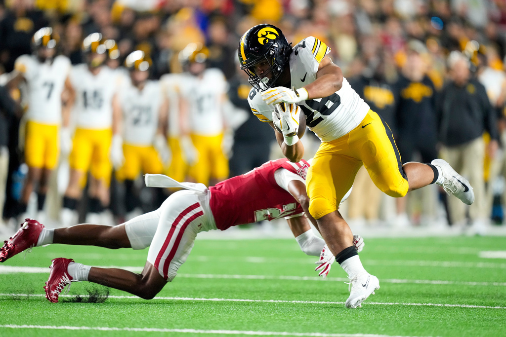 Iowa running back Xavier Williams (26) runs for a touchdown against Wisconsin during the second half of an NCAA college football game Saturday, Oct. 11, 2025, in Madison, Wis. (AP Photo/Andy Manis)