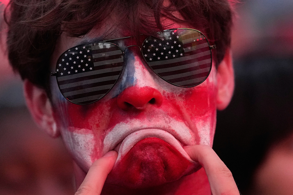 A fan reacts to a United States loss in a World Cup round of 16 soccer match against Belgium at the KC Live! entertainment district Monday, July 6, 2026, in Kansas City, Mo. (AP Photo/Charlie Riedel)