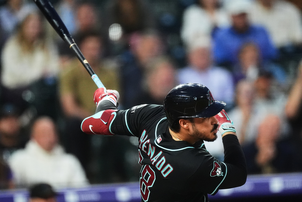 Arizona Diamondbacks' Nolan Arenado watches his RBI single off Colorado Rockies starting pitcher Mason Adams in the first inning of a baseball game Wednesday, Sept. 23, 2026, in Denver. (AP Photo/David Zalubowski)