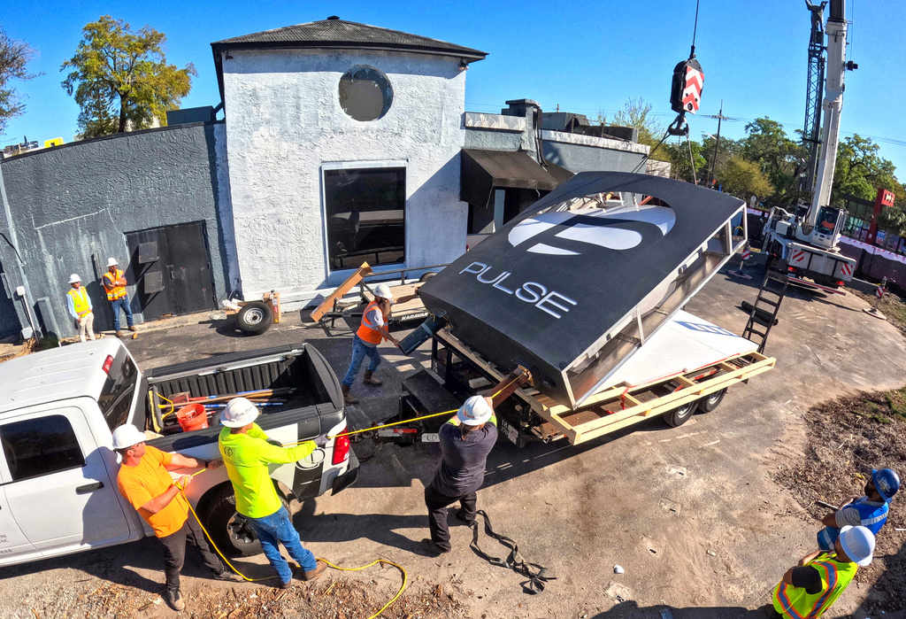 The sign for the Pulse nightclub is removed by workers, Wednesday, March 11, 2026, at the memorial site of the 2016 mass shooting in Orlando, Fla., that killed 49. (Joe Burbank/Orlando Sentinel)/Orlando Sentinel via AP)