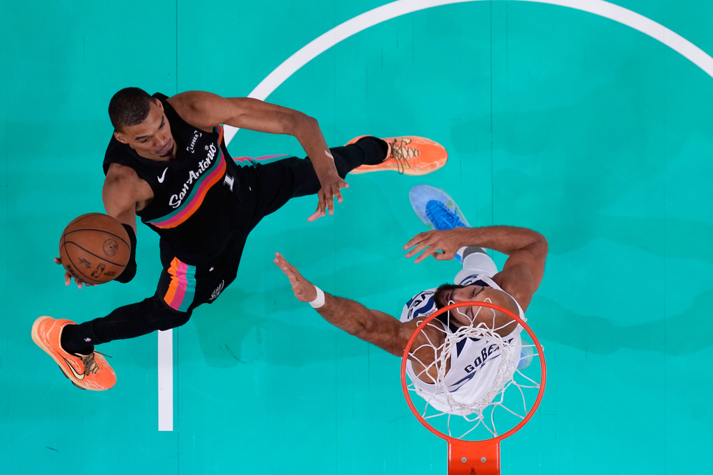 San Antonio Spurs forward Victor Wembanyama (1) drives to the basket against Minnesota Timberwolves center Rudy Gobert (27) during the first half in Game 1 of a second-round NBA playoffs basketball series in San Antonio, Monday, May 4, 2026. (AP Photo/Eric Gay)