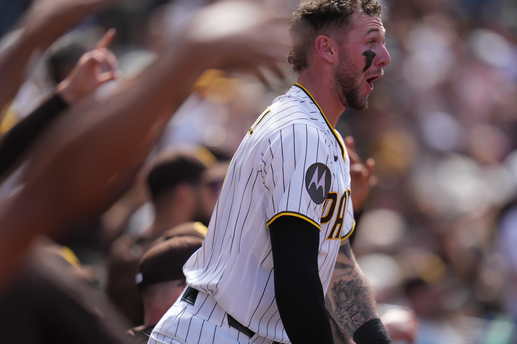 San Diego Padres center fielder Jackson Merrill celebrates with teammates after an RBI double by Gavin Sheets during the sixth inning of a baseball game against the San Francisco Giants Wednesday, April 1, 2026, in San Diego. (AP Photo/Gregory Bull)