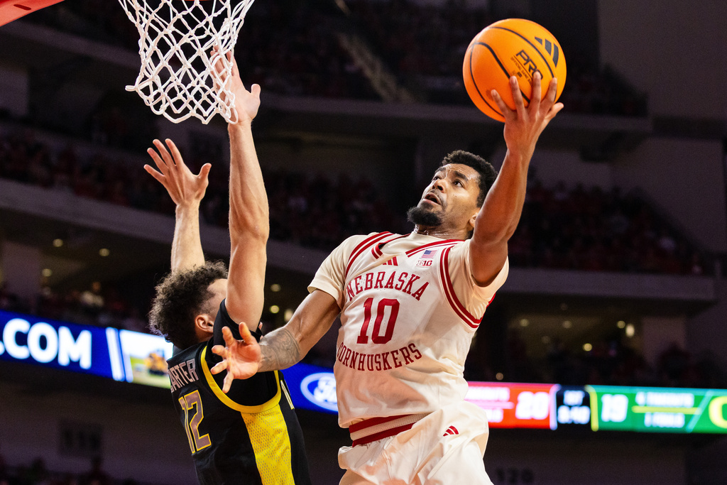 Nebraska guard Jamarques Lawrence (10) goes up for a layup against Oregon guard Drew Carter (12) during the first half of an NCAA college basketball game, Tuesday, Jan. 13, 2026, in Lincoln, Neb. (AP Photo/Bonnie Ryan)