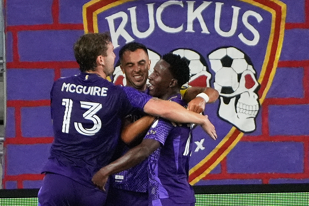 Orlando City midfielder Martin Ojeda, center, celebrates after scoring a goal against CF Montreal with forward Duncan McGuire (13) and Ivan Angulo during the first half of an MLS soccer match, Saturday, March 14, 2026, in Orlando, Fla. (AP Photo/John Raoux)