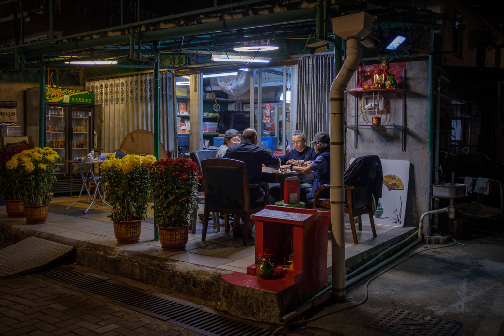 Local residents gather outside a shop on the first day of the Lunar New Year in Hong Kong, Feb. 17, 2026. (AP Photo/May James)