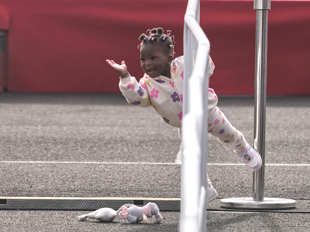 A girl plays as Pope Leo XIV arrives for a meeting with migrants at the Las Raíces reception center in San Cristóbal de La Laguna, Tenerife, Spain, Friday, June 12, 2026. (AP Photo/Arturo Rodriguez)