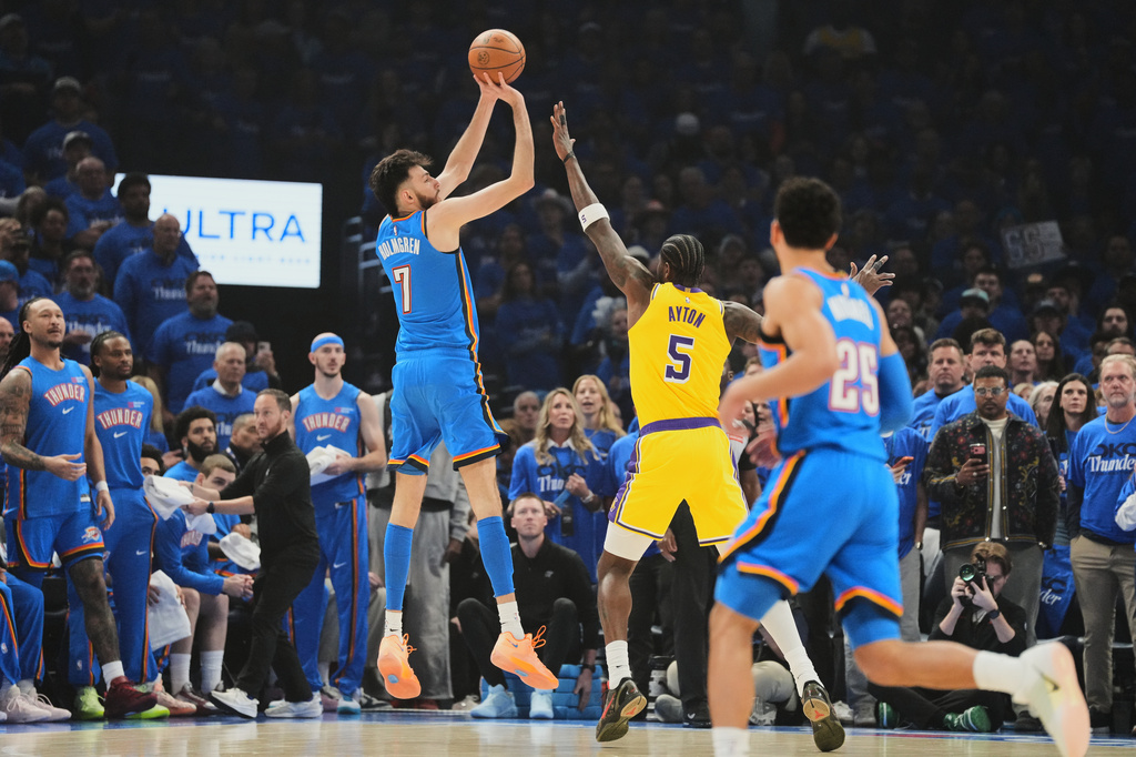 Oklahoma City Thunder center Chet Holmgren (7) shoots over Los Angeles Lakers center Deandre Ayton (5) as Ajay Mitchell (25) looks on in the first half of Game 1 in a second-round NBA basketball playoffs series Tuesday, May 5, 2026 in Oklahoma City. (AP Photo/Kyle Phillips)