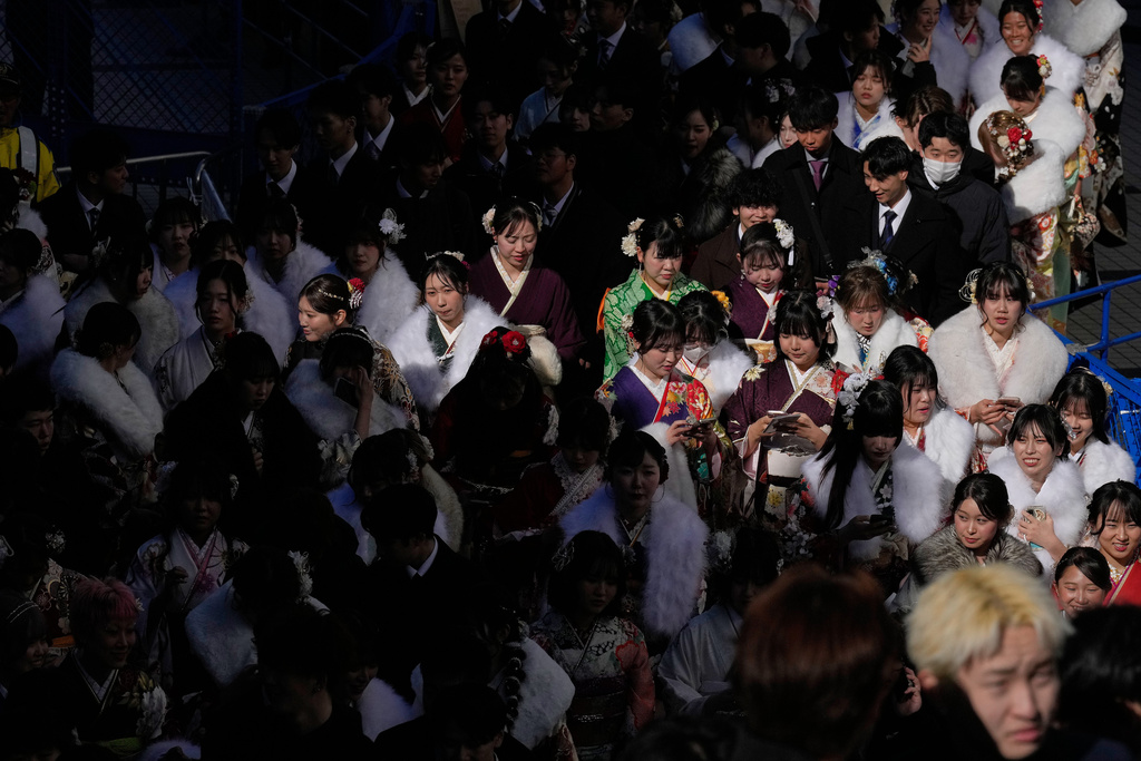 Young adults leave a venue after celebrating the Coming-of-Age Day, a centuries-old tradition and national holiday marking the milestone from childhood to adulthood, Monday, Jan. 12, 2026, in Yokohama near Tokyo. (AP Photo/Eugene Hoshiko)
