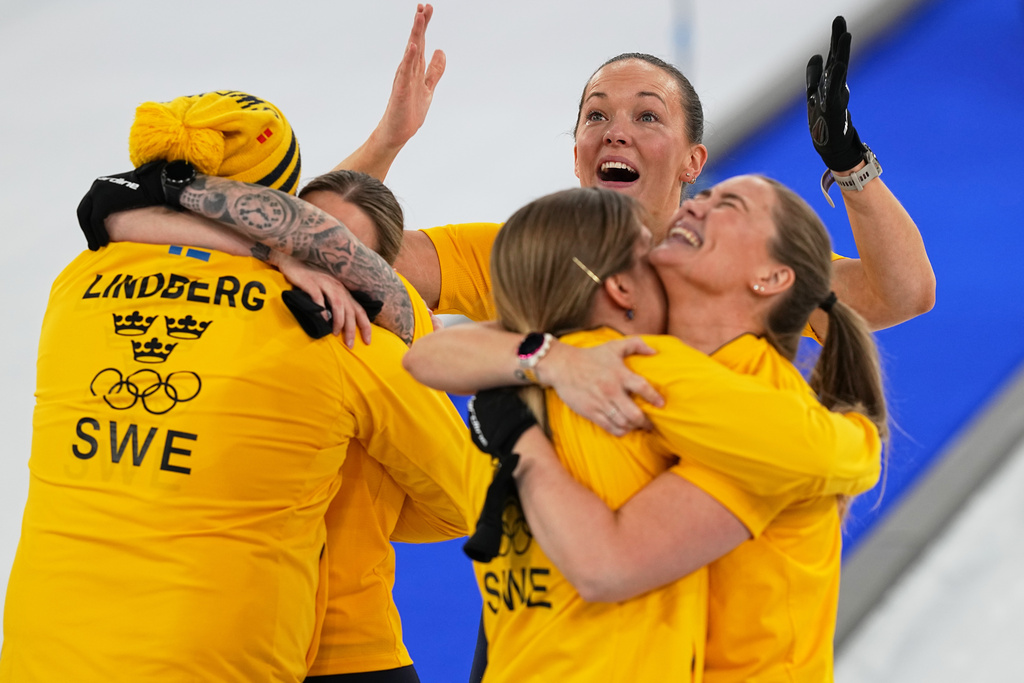 Team Sweden celebrates defeating Switzerland to win a women's curling gold medal match, at the 2026 Winter Olympics, in Cortina d'Ampezzo, Italy, Sunday, Feb. 22, 2026.(AP Photo/Fatima Shbair)