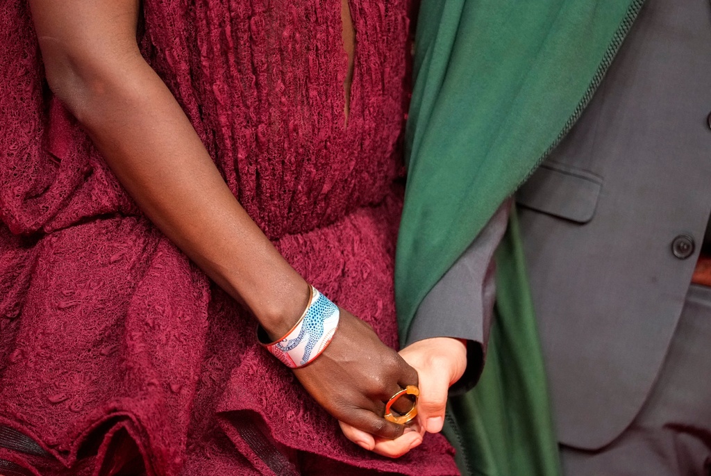 A couple poses for a photo on the red carpet during the 22nd Marrakech Film Festival, in Morocco, Tuesday, Dec. 2, 2025. (AP Photo/Mosa'ab Elshamy)