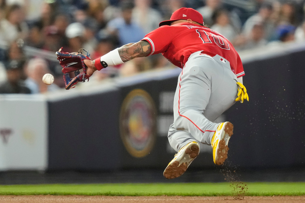 Los Angeles Angels third baseman Yoán Moncada (10) dives for a ball hit by New York Yankees' Ryan McMahon during the third inning of a baseball game, Tuesday, April 14, 2026, in New York. (AP Photo/Yuki Iwamura)