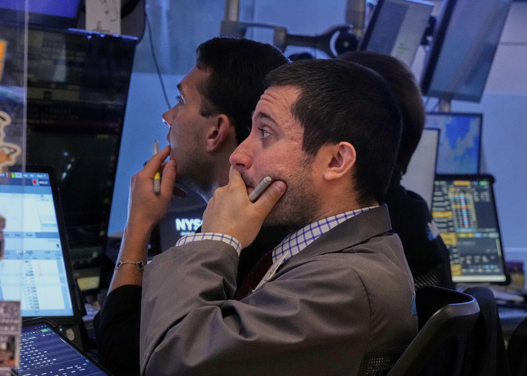 Trader Drew Cohen, foreground, works with colleagues on the floor of the New York Stock Exchange, Friday, Sept. 5, 2025. (AP Photo/Richard Drew)