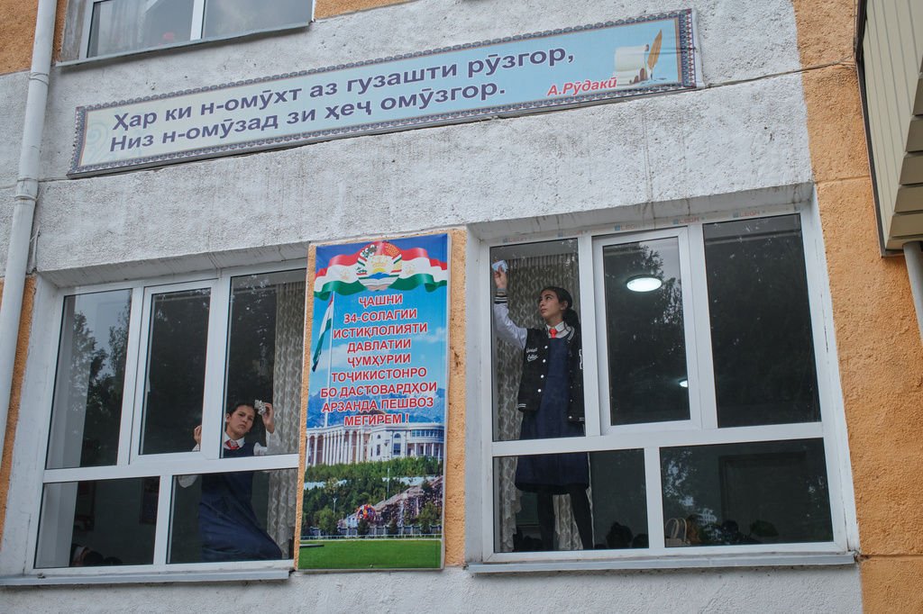 Students clean classroom windows ahead of a visit from a district official, in Panjakent, Tajikistan, Monday, May 4, 2026. (AP Photo/Jon Orbach)