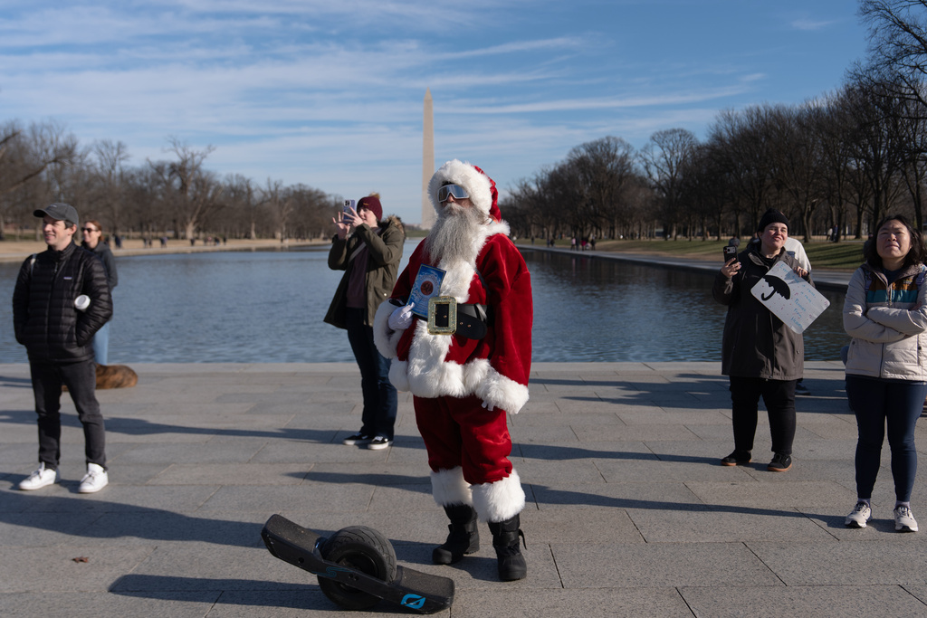 A person dressed as Santa attends a mock funeral for the penny, which was discontinued earlier this year, Saturday, Dec. 20, 2025, in front of the Lincoln Memorial in Washington. (AP Photo/Julia Demaree Nikhinson)
