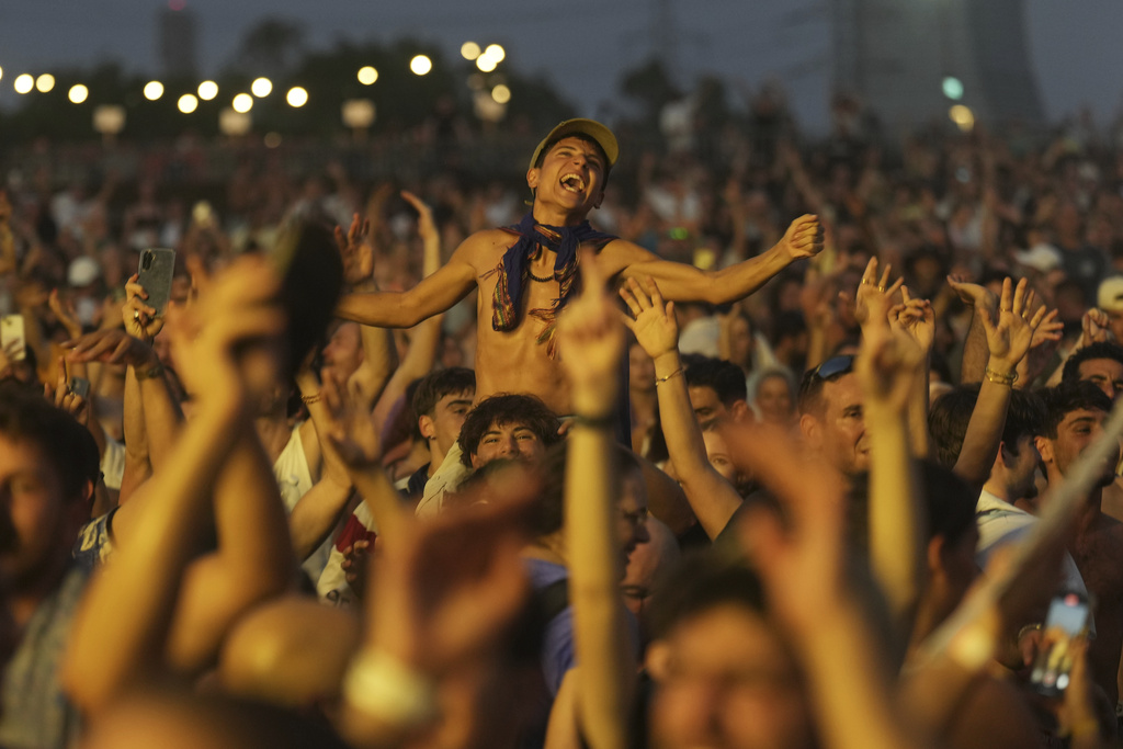 People attend the Nova Healing Concert in Tel Aviv, Israel, Aug. 14, 2025, at the second Tribe of Nova mass gathering since the Oct. 7, 2023, cross-border attack by Hamas that left hundreds at the Nova music festival dead or kidnapped to the Gaza Strip. (AP Photo/Ariel Schalit)