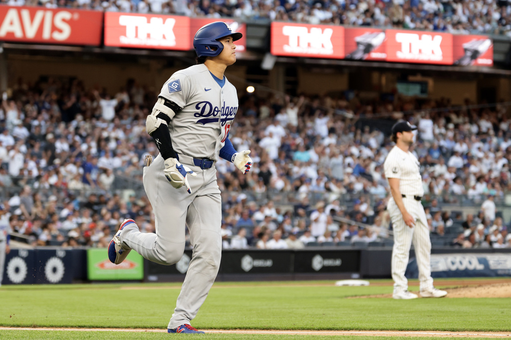 Los Angeles Dodgers designated hitter Shohei Ohtani, left, watches his flyout off New York Yankees pitcher Gerrit Cole during the third inning of a baseball game Friday, July 17, 2026, in New York. (AP Photo/Adam Hunger)