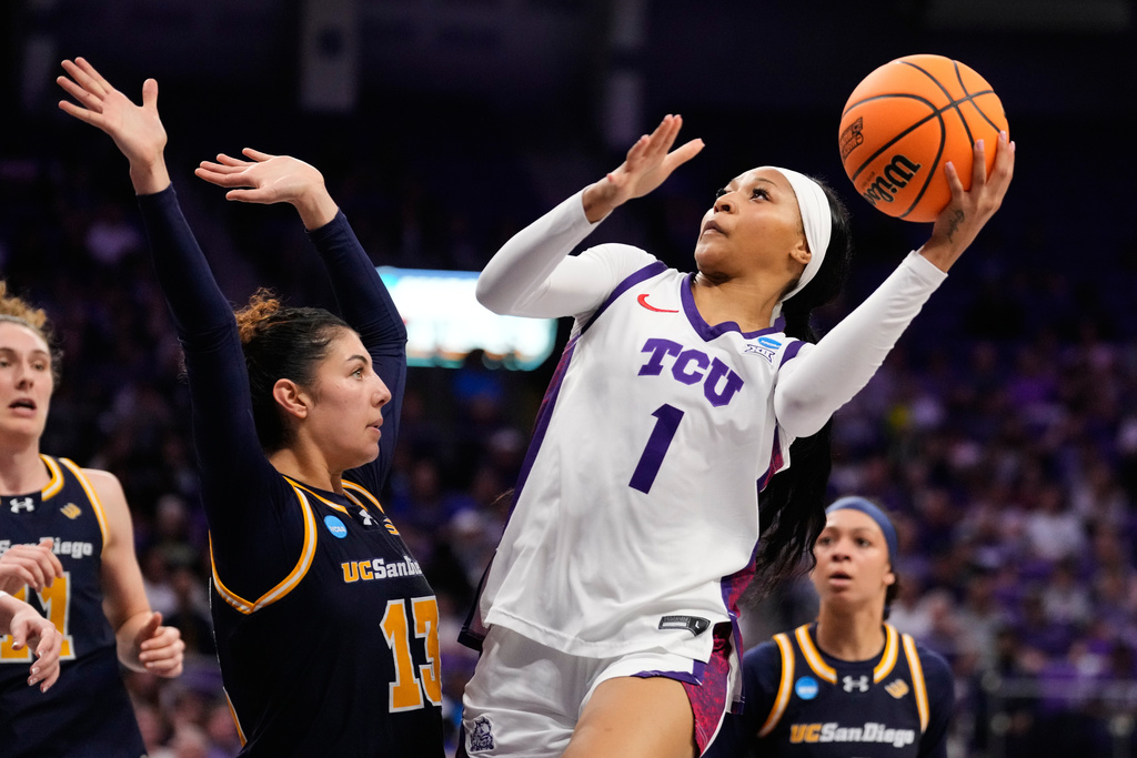 TCU guard Taylor Bigby (1) shoots over UC San Diego's Lev Feiman (13) in the second half in the first round of the NCAA college basketball tournament, Friday, March 20, 2026, in Fort Worth, Texas. (AP Photo/Tony Gutierrez)