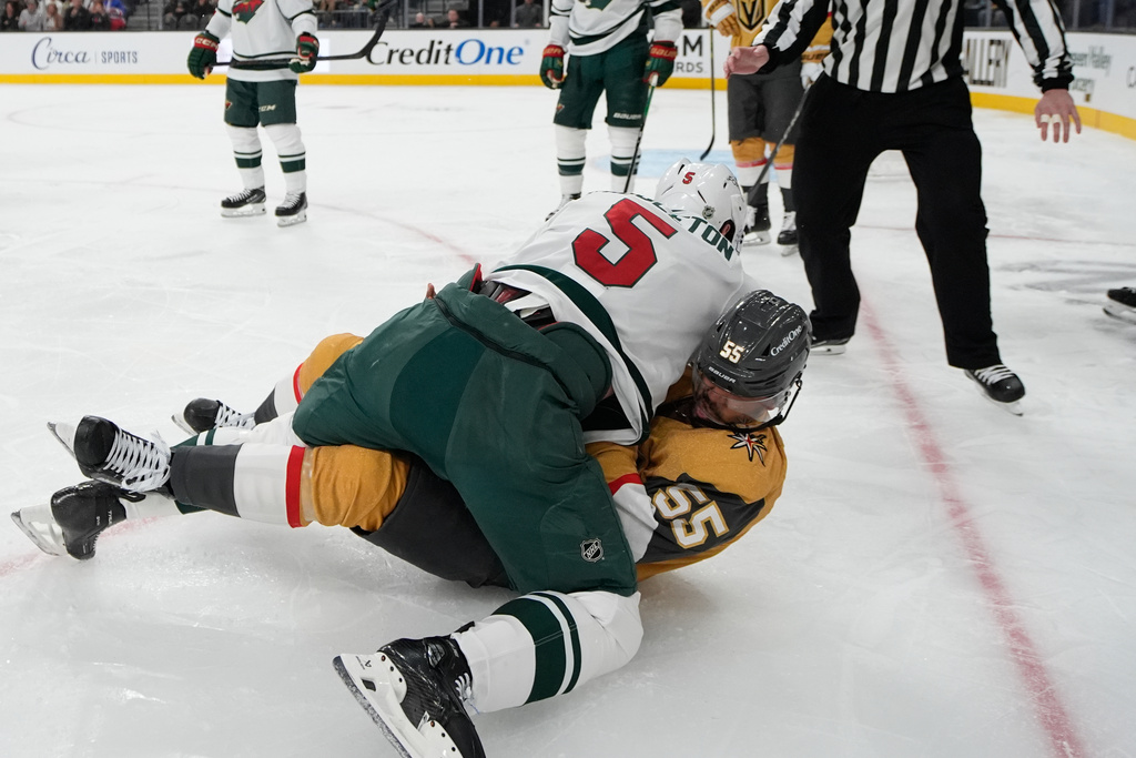 Minnesota Wild defenseman Jake Middleton, left, and Vegas Golden Knights right wing Keegan Kolesar (55) fight during the second period of an NHL hockey game Friday, March 6, 2026, in Las Vegas. (AP Photo/John Locher)