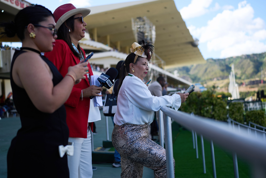 Spectators attend the 56th Jockey Challenge at the Rinconada racetrack in Caracas, Venezuela, Sunday, Dec. 14, 2025. (AP Photo/Ariana Cubillos)