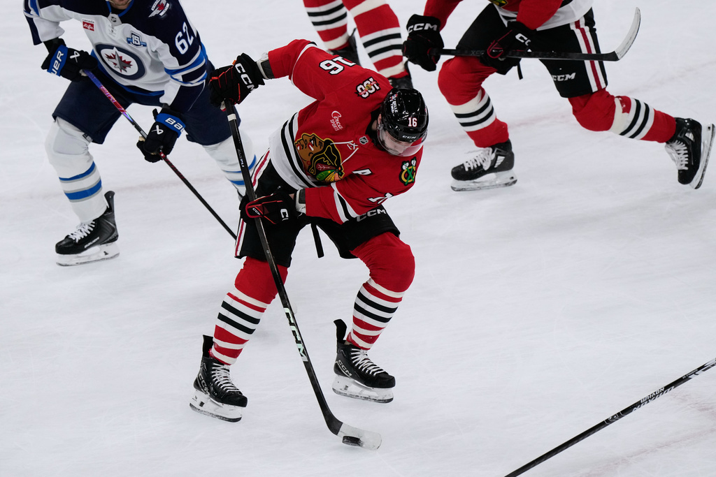 Chicago Blackhawks center Jason Dickinson (16) controls the puck during the first period of an NHL hockey game against the Winnipeg Jets in Chicago, Monday, Jan. 19, 2026. (AP Photo/Nam Y. Huh)