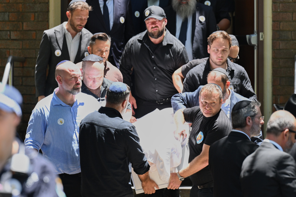 Family carry the coffin following a service for Bondi Beach mass shooting victim 10-year-old Matilda, whose last name is being withheld at the request of her family, in Sydney, Thursday, Dec. 18, 2025. (AP Photo/Steve Markham)