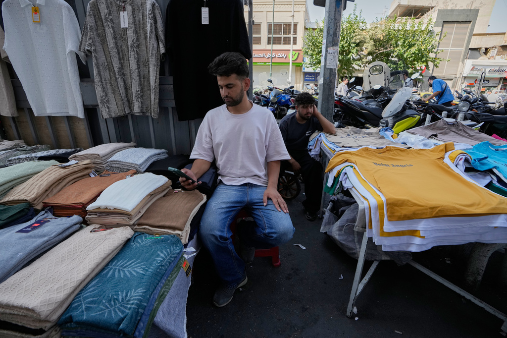 Street vendors wait for customers around Tehran's Grand Bazaar in Tehran, Iran, Monday, Aug. 24, 2026. (AP Photo/Vahid Salemi)