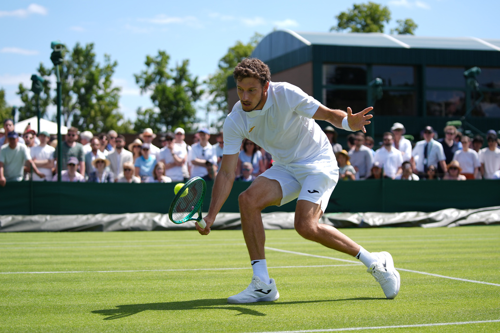 Pablo Carreno Busta of Spain returns the ball to Denis Shapovalov of Canada in their first round men's singles match at the Wimbledon Tennis Championships in London, Monday, June 29, 2026. (AP Photo/Maja Smiejkowska)