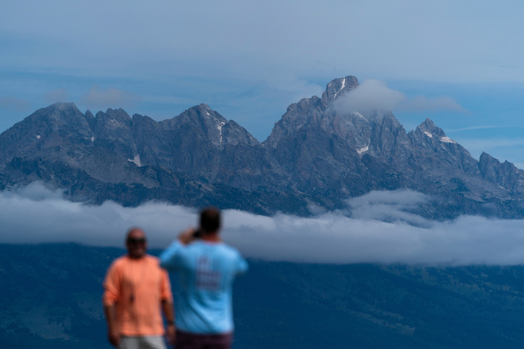 FILE - Tourists take photos in Grand Teton National Park, Wyo., Aug. 14, 2022. (AP Photo/Jae C. Hong, File)