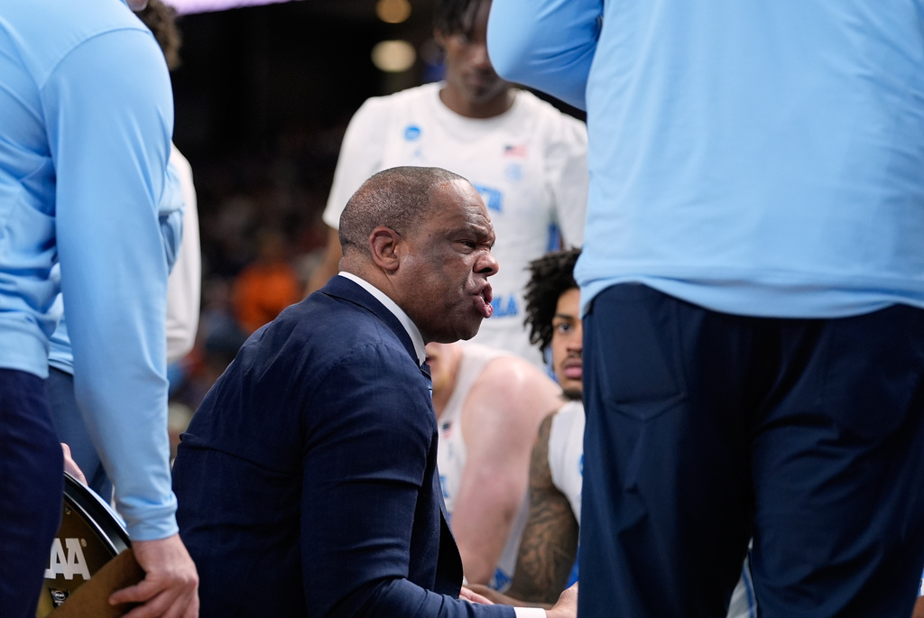 North Carolina head coach Hubert Davis talks with his team during the second half in the first round of the NCAA college basketball tournament against Virginia Commonwealth, Thursday, March 19, 2026, in Greenville, S.C. (AP Photo/Brynn Anderson)