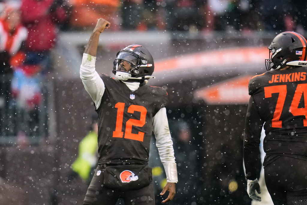 Cleveland Browns' Shedeur Sanders (12) and Teven Jenkins (74) celebrate a touchdown in the first half of an NFL football game against the Tennessee Titans in Cleveland, Sunday, Dec. 7, 2025. (AP Photo/Sue Ogrocki)