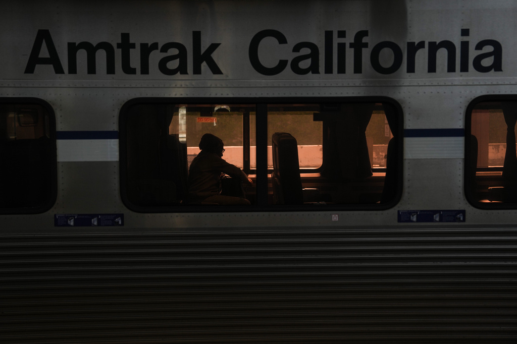 A passenger sits aboard an Amtrak train at Union Station in Los Angeles, Thursday, April 30, 2026. (AP Photo/Jae C. Hong)
