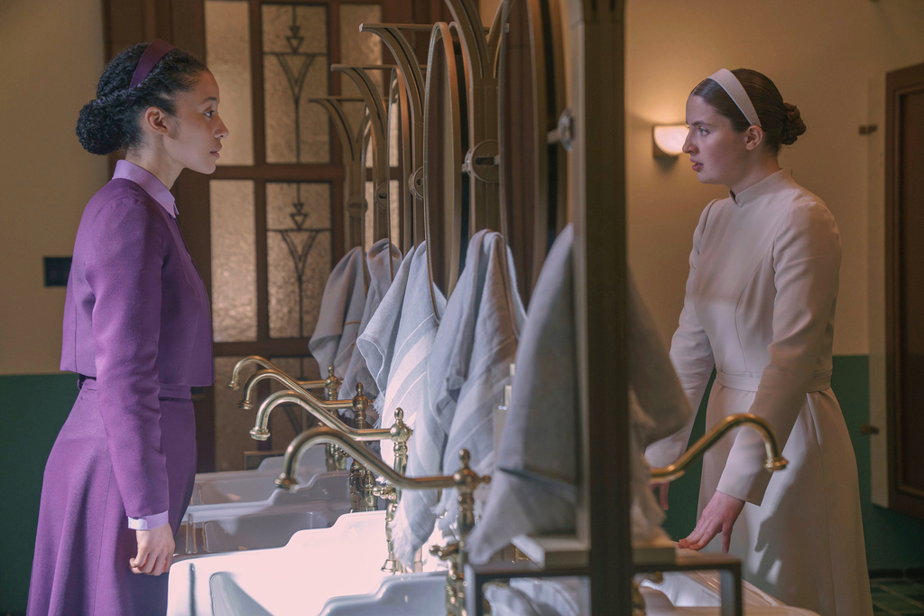 This image released by Disney shows Chase Infiniti, left, and Lucy Halliday in a scene from "The Testaments." (Steve Wilkie/Disney via AP)