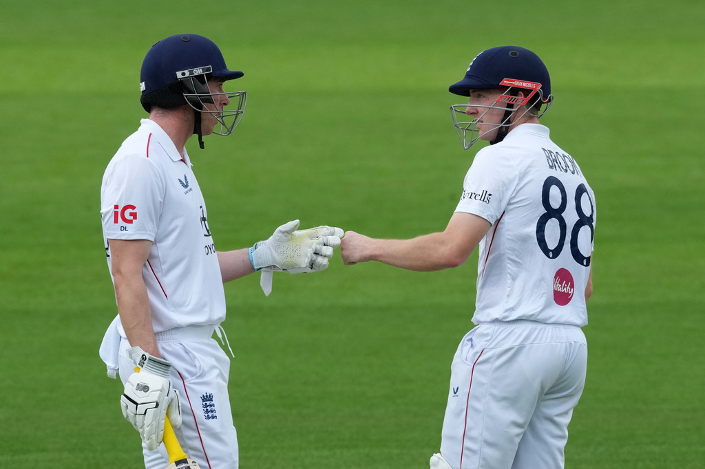 England's Harry Brook, left, and batting partner Dan Lawrence touch gloves on day three of the second cricket test match between England and Pakistan in London, Saturday, Aug. 29, 2026. (AP Photo/Dave Shopland)