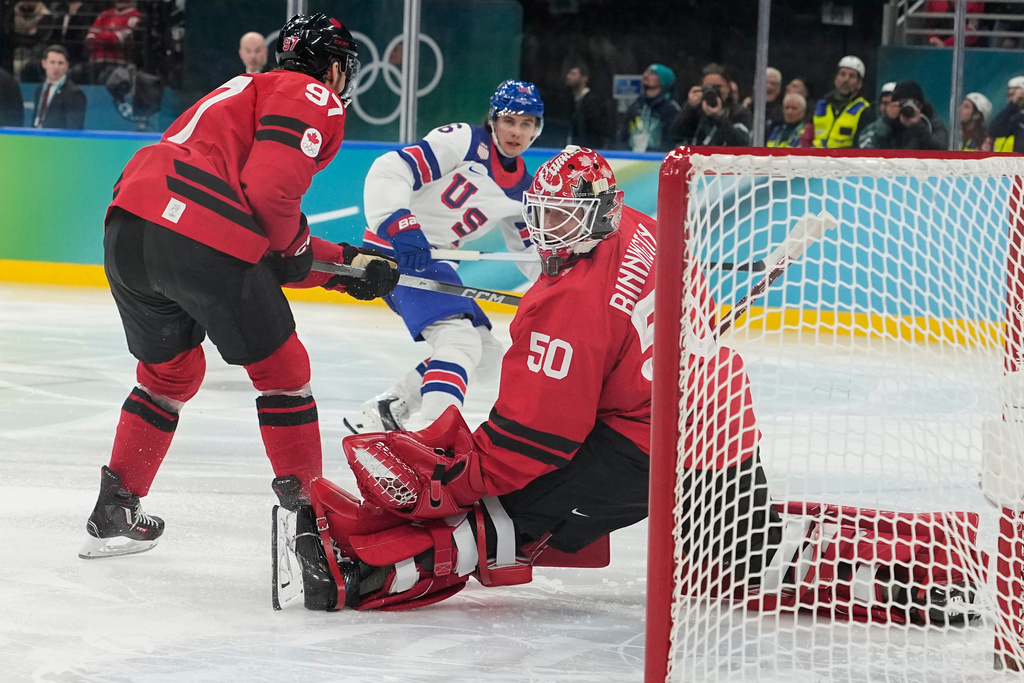 United States' Jack Hughes (86) scores during a men's ice hockey gold medal game between Canada and the United States at the 2026 Winter Olympics, in Milan, Italy, Sunday, Feb. 22, 2026. (AP Photo/Hassan Ammar)