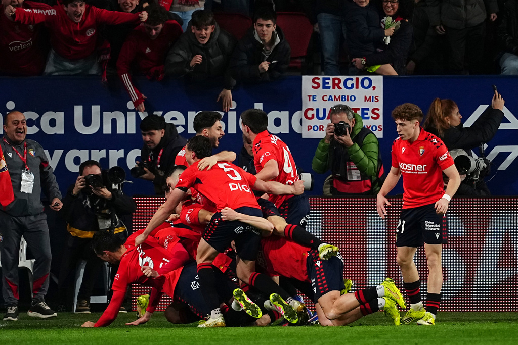 Osasuna's Raul Garcia celebrates with his teammates after scoring his side's second goal during a Spanish La Liga soccer match between Osasuna and Real Madrid in Pamplona, Spain, Saturday, Feb. 21, 2026. (AP Photo/Miguel Oses)