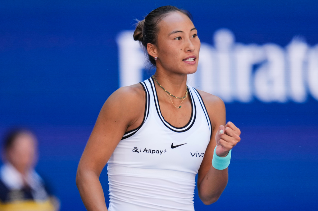 Qinwen Zheng, of China, reacts during a match against Iga Swiatek, of Poland, during the fourth round of the U.S. Open tennis championships, Monday, Sept. 7, 2026, in New York. (AP Photo/Seth Wenig)