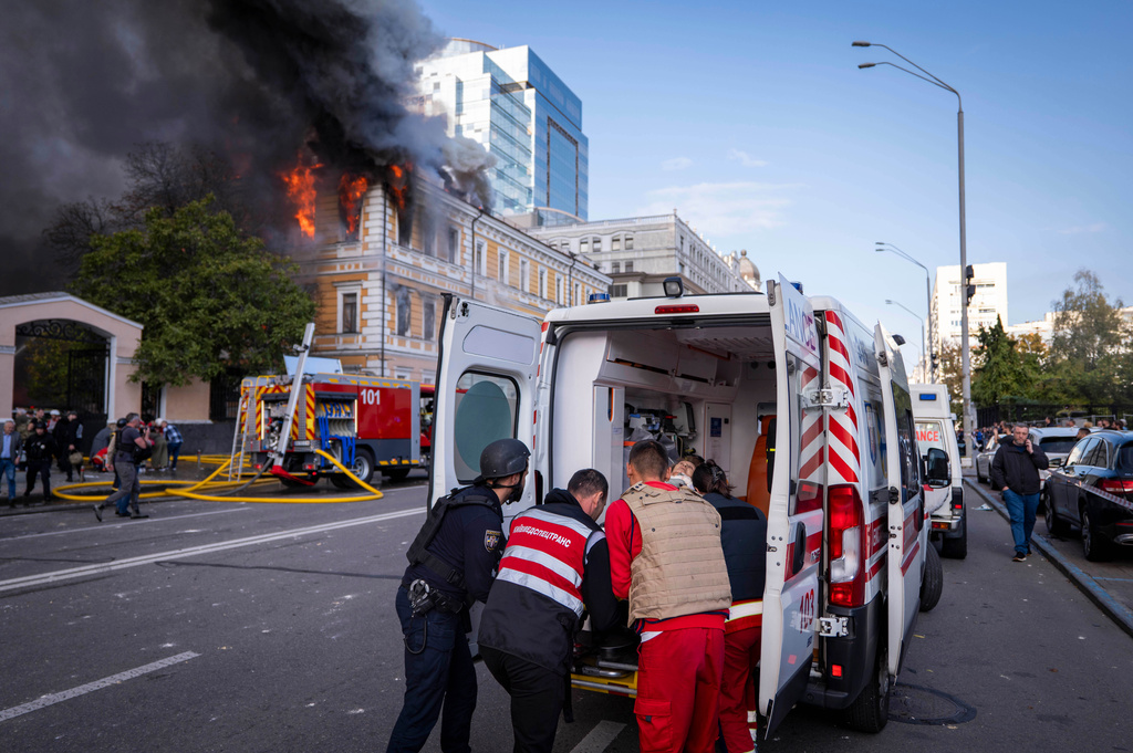 Paramedics evacuate an injured woman into an ambulance in front of the National Academy of Sciences building damaged after a Russian drone strike in the center of Kyiv, Ukraine, Monday, Sept. 28, 2026. (AP Photo/Dan Bashakov)