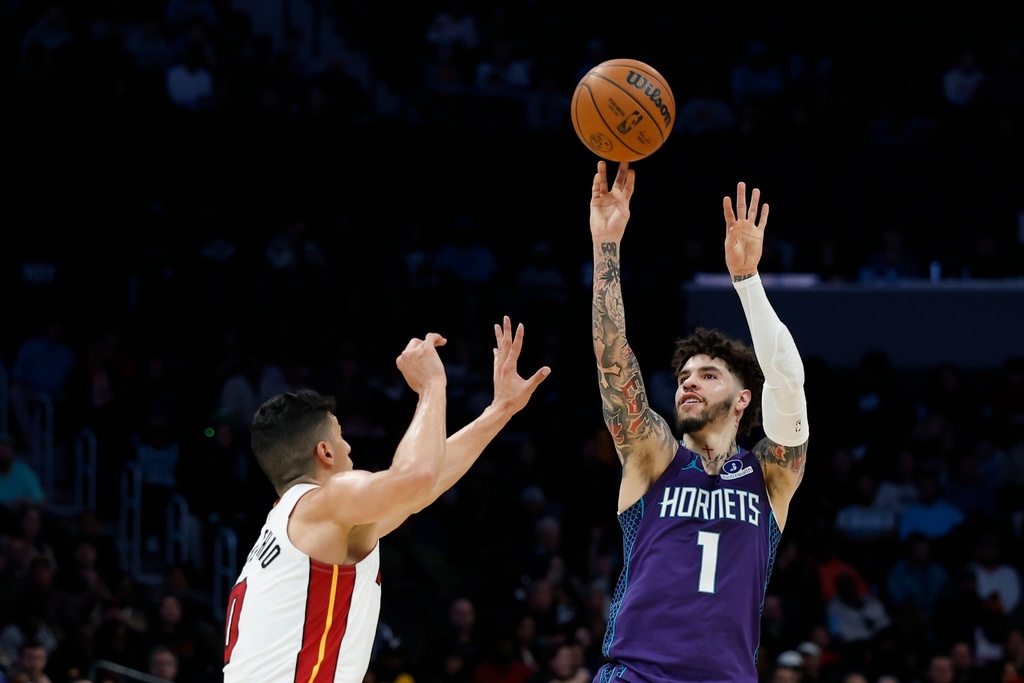Charlotte Hornets guard LaMelo Ball (1) shoots over Miami Heat forward Simone Fontecchio during the first half of an NBA basketball game, Tuesday, March 17, 2026, in Charlotte, N.C. (AP Photo/Nell Redmond)