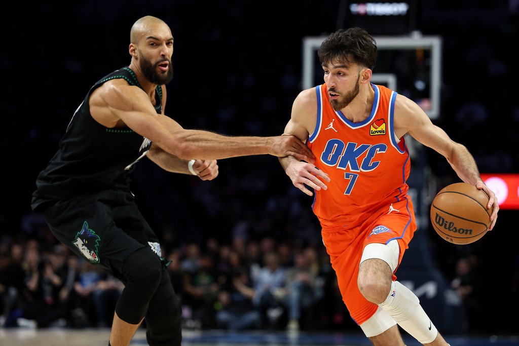 Oklahoma City Thunder center Chet Holmgren, right, works around Minnesota Timberwolves center Rudy Gobert, left, during the first half of an NBA basketball game, Thursday, Jan. 29, 2026, in Minneapolis. (AP Photo/Matt Krohn)
