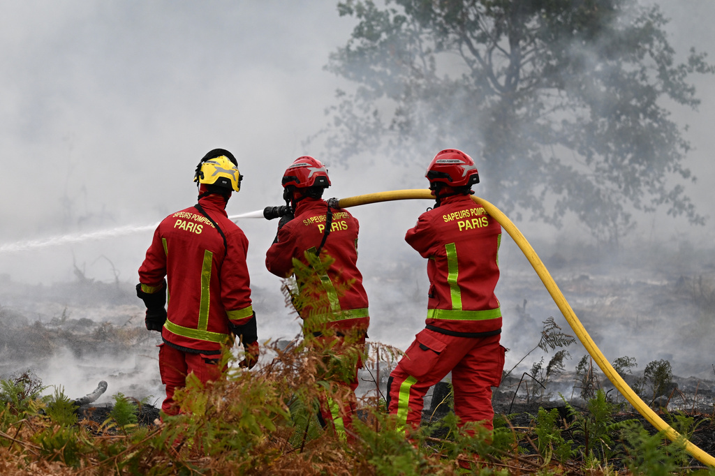 Firefighters from Paris battle a wildfire near Marcheprime, outside, Bordeaux, France, Sunday, July 26, 2026. (AP Photo/Emma Da Silva)