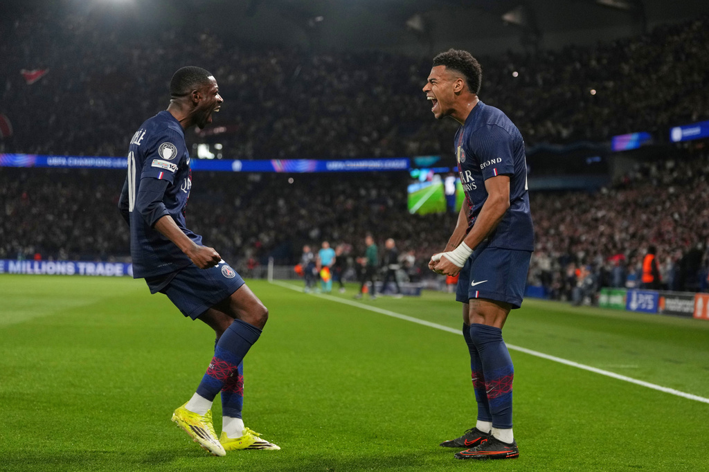 PSG's Desire Doue, right, celebrates with PSG's Ousmane Dembele after scoring the opening goal during the Champions League quarterfinal first leg soccer match between Paris Saint-Germain and Liverpool in Paris, Wednesday, April 8, 2026. (AP Photo/Thibault Camus)