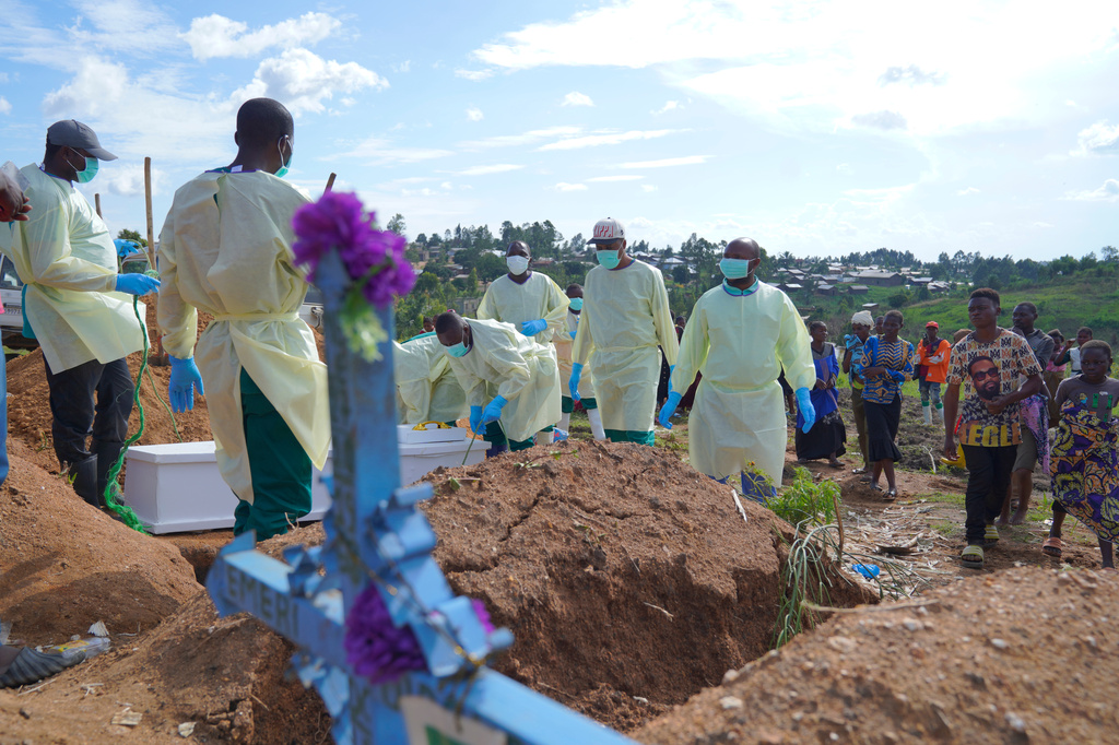 Healthcare workers take part in a burial for Joseline Ngonji Kale, a 55 year old woman who was killed by the Ebola virus, in Bunia, Congo, Friday, Oct. 30, 2026. (AP Photo/Dieudonne Dirole)